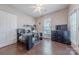 Bright office area with a glass desk, plenty of shelving, wood floor and natural light at 8603 Bookwalter Ct, Charlotte, NC 28277