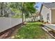 Backyard featuring a white privacy fence and some trees and grassy areas at 9189 Glenashley Dr, Cornelius, NC 28031