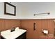 Bathroom featuring single sink vanity with framed mirror and wainscoting at 9189 Glenashley Dr, Cornelius, NC 28031