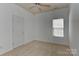 Spacious bedroom with neutral carpet, ceiling fan, and a window at 9189 Glenashley Dr, Cornelius, NC 28031