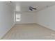 Bright bedroom with neutral carpet, a window, and a ceiling fan at 9189 Glenashley Dr, Cornelius, NC 28031