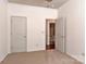Carpeted bedroom with an open doorway to a bathroom at 9189 Glenashley Dr, Cornelius, NC 28031
