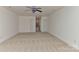 A spacious carpeted bonus room with a ceiling fan and two entry doors at 9189 Glenashley Dr, Cornelius, NC 28031
