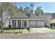 Charming home features a two-car garage, well-manicured lawn, and a cozy covered front porch with classic white columns at 9189 Glenashley Dr, Cornelius, NC 28031