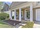Charming front porch with classic columns, manicured landscaping, and a welcoming entrance showcasing the home's curb appeal at 9189 Glenashley Dr, Cornelius, NC 28031