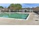 A community pool with a green cover, deck furniture, and restroom facilities at 9189 Glenashley Dr, Cornelius, NC 28031