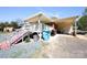 Inviting back exterior with a covered deck, stairs, and a side storage area at 9716 Sunway Dr, Mint Hill, NC 28227