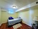 Small basement bedroom featuring hardwood floors, a window for natural light, and a comfortable bed at 9716 Sunway Dr, Mint Hill, NC 28227