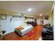Cozy basement area with hardwood floors, seating, and decor for a comfortable living space at 9716 Sunway Dr, Mint Hill, NC 28227