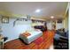 Cozy basement area with hardwood floors, seating, and decor for a comfortable living space at 9716 Sunway Dr, Mint Hill, NC 28227