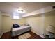A modest bedroom with hardwood floors, minimal decor, and warm lighting at 9716 Sunway Dr, Mint Hill, NC 28227