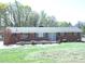 Charming single-story brick home with a well-maintained front yard, featuring a blend of mature trees at 9716 Sunway Dr, Mint Hill, NC 28227