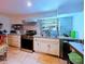 Updated kitchen featuring granite countertops, stainless steel appliances, tile backsplash, and updated cabinets at 9716 Sunway Dr, Mint Hill, NC 28227