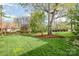 Expansive backyard with lush green grass, mature trees, and a charming swing at 10 North Rd, Salisbury, NC 28144