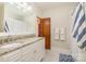 Bathroom with dual sinks, granite countertops, and a shower at 10 North Rd, Salisbury, NC 28144