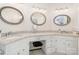 Bathroom featuring dual sinks, granite countertops, and decorative mirrors at 10 North Rd, Salisbury, NC 28144