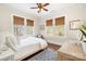Bright bedroom boasts hardwood floors, woven shades, and a ceiling fan at 10 North Rd, Salisbury, NC 28144