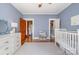 Bedroom featuring blue walls, a crib, and a convenient closet at 10 North Rd, Salisbury, NC 28144