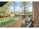 Relaxing deck with chairs overlooking the landscaped backyard and golf course views at 10 North Rd, Salisbury, NC 28144