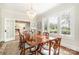 Classic dining area featuring a wood table, chandelier, and large windows with view to outside at 10 North Rd, Salisbury, NC 28144