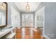 Grand foyer with gleaming hardwood floors, decorative wallpaper, and a stylish pendant light fixture at 10 North Rd, Salisbury, NC 28144
