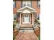 Classic brick home featuring an elegant front entrance with stately columns and decorative planters at 10 North Rd, Salisbury, NC 28144