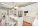Bright kitchen featuring white cabinetry, modern stainless steel appliances and terracotta flooring at 10 North Rd, Salisbury, NC 28144