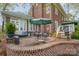 Outdoor brick patio with seating, a grill, and stairs leading to a wooden deck with views of the house at 10 North Rd, Salisbury, NC 28144