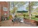Outdoor patio featuring a dining table and chairs with an umbrella next to a brick home at 10 North Rd, Salisbury, NC 28144