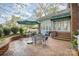 Outdoor brick patio featuring a seating area with an umbrella and view of the home's exterior at 10 North Rd, Salisbury, NC 28144