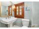 Stylish powder room featuring a pedestal sink and vintage-style fixtures and custom window at 10 North Rd, Salisbury, NC 28144