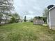 Grassy backyard featuring wooden fence, view of neighborhood, and home's exterior at 10400 Brawley Ln # 8, Charlotte, NC 28215
