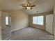 Bright bedroom with neutral walls, carpeting, a ceiling fan, and a window offering ample natural light and a closet at 10400 Brawley Ln # 8, Charlotte, NC 28215