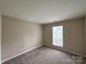 Bedroom featuring carpet flooring, window, and electrical outlets at 10400 Brawley Ln # 8, Charlotte, NC 28215