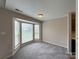 Bright dining area with a bay window, neutral walls, and carpeting, offering a cozy space for meals at 10400 Brawley Ln # 8, Charlotte, NC 28215
