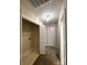 Neutral hallway with laundry closet, chandelier lighting, and carpeted flooring at 10400 Brawley Ln # 8, Charlotte, NC 28215