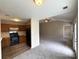 Open-concept living space featuring a kitchen, living room with fireplace, and neutral carpeting for a cozy feel at 10400 Brawley Ln # 8, Charlotte, NC 28215