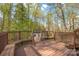 Spacious stained back deck with wooded view, built-in bench seating and decorative lattice detail at 125 Cove Creek Loop # 18, Mooresville, NC 28117