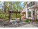 Backyard features a wooden pergola and landscaped garden at 125 Cove Creek Loop # 18, Mooresville, NC 28117