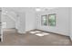 An airy bedroom features natural light from several windows and neutral carpet throughout at 125 Cove Creek Loop # 18, Mooresville, NC 28117