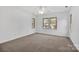 This spacious bedroom features neutral carpeting and multiple windows for natural light at 125 Cove Creek Loop # 18, Mooresville, NC 28117