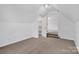 This attic bedroom features neutral carpeting and an attached room at 125 Cove Creek Loop # 18, Mooresville, NC 28117