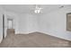 A serene bedroom features a ceiling fan and large windows providing natural light and scenic views at 125 Cove Creek Loop # 18, Mooresville, NC 28117