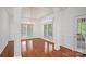 Elegant dining room with natural light, hardwood floors, and decorative columns at 125 Cove Creek Loop # 18, Mooresville, NC 28117