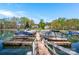 Community boat dock and boat slips with boats on calm water with lakeside homes in the background at 125 Cove Creek Loop # 18, Mooresville, NC 28117
