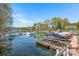 Community boat dock with boat slips on calm water and lakeside homes in the background at 125 Cove Creek Loop # 18, Mooresville, NC 28117