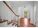 Bright foyer with hardwood floors and staircase with wood railing at 125 Cove Creek Loop # 18, Mooresville, NC 28117