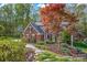 Brick home with lush landscaping and a stone pathway at 125 Cove Creek Loop # 18, Mooresville, NC 28117