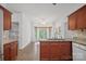 Open-concept kitchen with granite countertops, cherry wood cabinets, and adjoining breakfast area at 125 Cove Creek Loop # 18, Mooresville, NC 28117