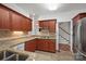 Functional kitchen with granite countertops, tile backsplash, and custom cherry wood cabinetry at 125 Cove Creek Loop # 18, Mooresville, NC 28117